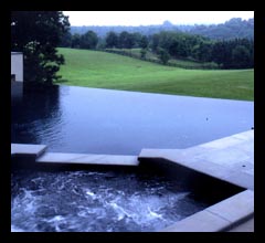 Swimming pool with disappearing edge and hot tub spa in Albemarle County, designed by Candace Smith Architect