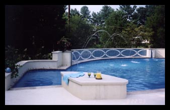 New swimming pool with water jets and fountains and custom tile work as additions to home in Charlottesville, Virginia, designed by architect Candace Smith, AIA