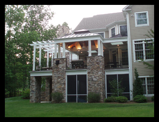 New porch and pergola with fieldstone walls and screened porch additions designed by Candace Smith Architect, for contemporary Virginia home